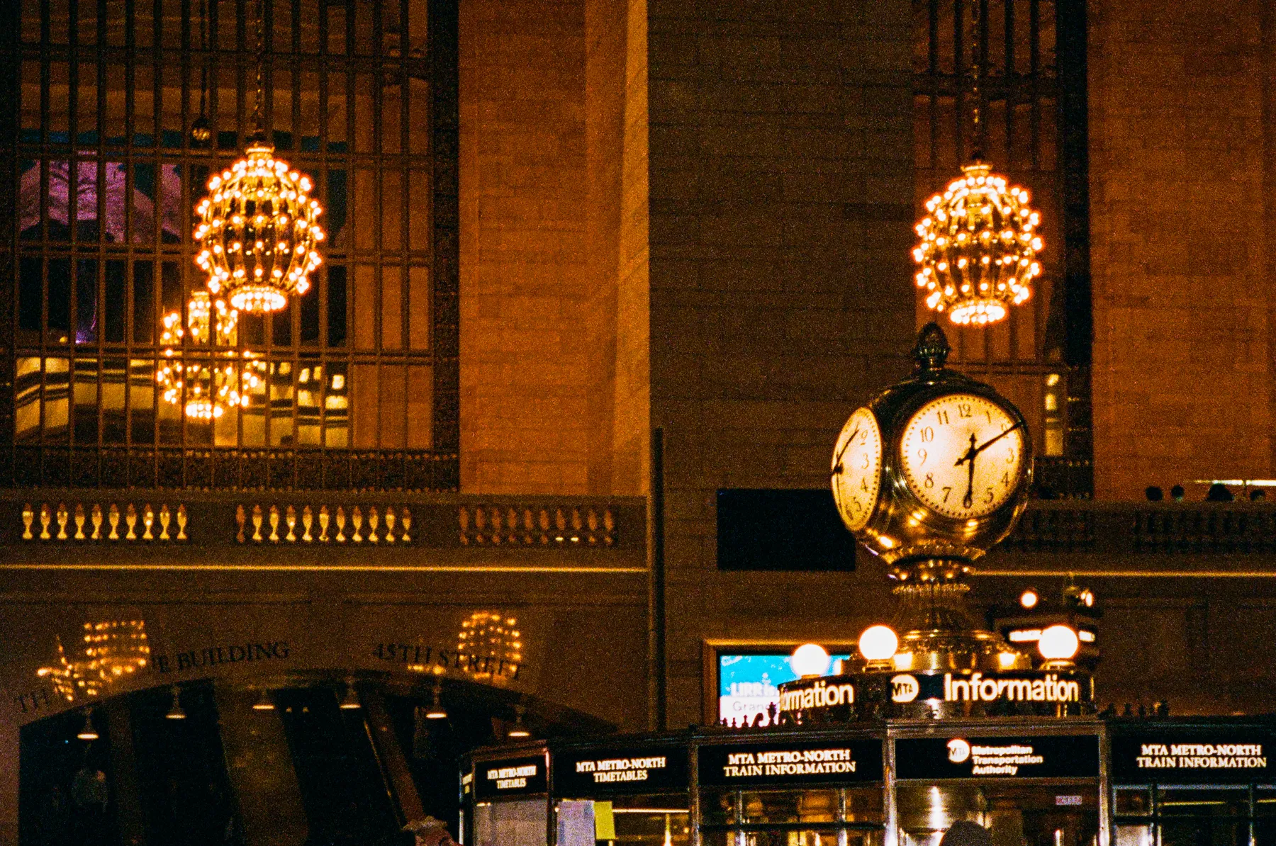 the brass clock and chandeliers of grand central station, new york